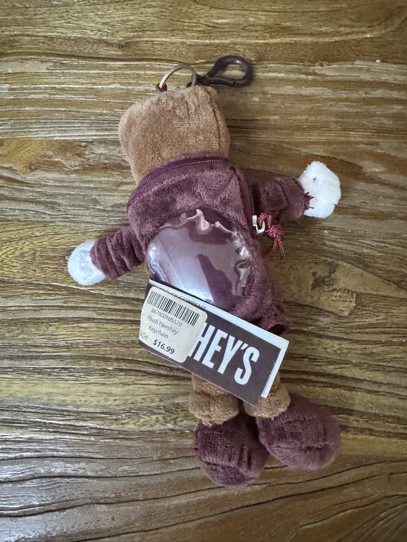 Hershey's Plush Hershey Keychain with Hoodie (Category: Plushies & Soft Toys) located in Las Pinas. Submitted by emdjss (Listing ID 1470794077, Image 2). Description: - Official Hershey's character plush keychain - Wears a stylish brown hoodie with the classic HERSHEY'S logo - Features a practical clear plastic pocket window on the back - Equipped with a sturdy plastic clip for easy attachment to bags or keys - Brand new with original store tag a