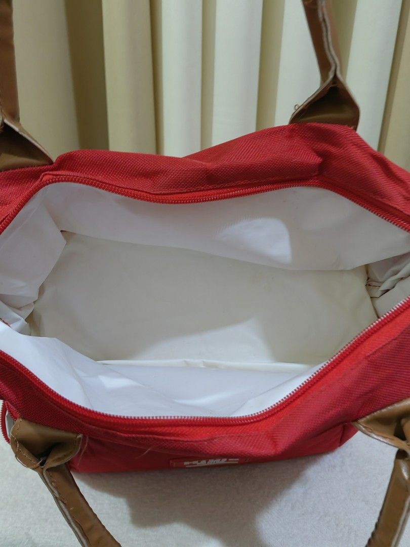 Hikid Red Insulated Double Deck Cooler Bag (Category: Food Organization & Storage) located in Makati City. Submitted by prelovedtreatedwithlove (Listing ID 1470870296, Image 3). Description: - Brand/Model: Red Hikid cooler bag with stylish brown handles - Double Deck Layout: Two separate compartments with clean white wipeable lining - Storage Features: Convenient front slip pocket on the lower section - Versatile Design: Side rings included for a