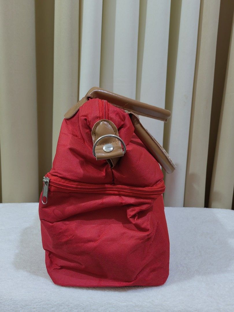 Hikid Red Insulated Double Deck Cooler Bag (Category: Food Organization & Storage) located in Makati City. Submitted by prelovedtreatedwithlove (Listing ID 1470870296, Image 2). Description: - Brand/Model: Red Hikid cooler bag with stylish brown handles - Double Deck Layout: Two separate compartments with clean white wipeable lining - Storage Features: Convenient front slip pocket on the lower section - Versatile Design: Side rings included for a