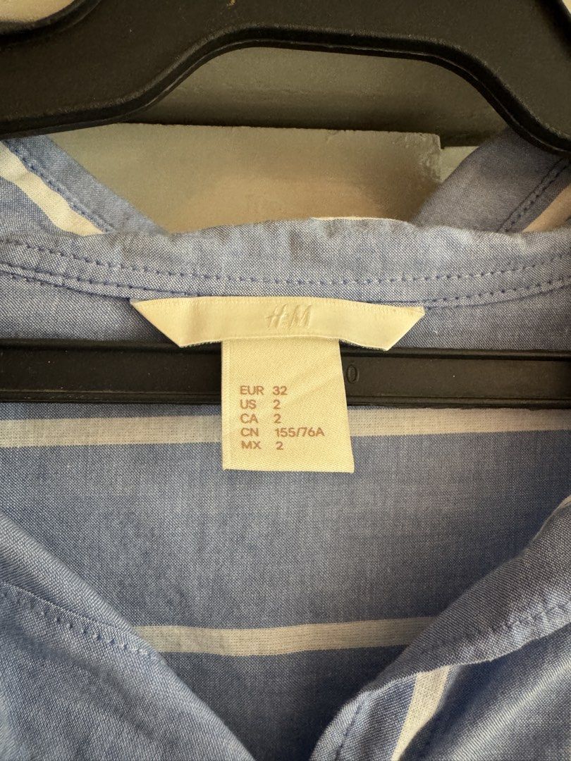 H&M Blue White Striped Long Sleeve Button Down Shirt (Category: Longsleeves) located in Taytay. Submitted by darkswan016 (Listing ID 1470830363, Image 2). Description: - Brand: H&M - Color: Light blue and white stripes - Size: US 2, EUR 32, CN 155/76A - Fit: Relaxed fit with an asymmetrical curved hem (longer back) - Details: Classic collar, front button closure, single chest pocket, long sleeves with button cuffs - Fabric: Breathable and lightwe
