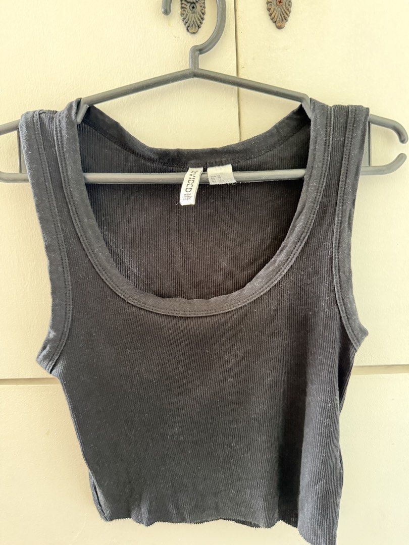 H&M Divided Black Ribbed Tank Top (Category: Sleeveless) located in Manila. Submitted by mnlclaudia (Listing ID 1470791001, Image 1). Description: - Brand: H&M Divided - Style: Black ribbed tank top with scoop neckline and sleeveless cut - Size: XS (EUR/US) - Material: Stretchy, body-hugging cotton blend - Condition: Minimal wear, excellent basic staple - Styling: Perfect for layering or pairing with jeans and shorts.