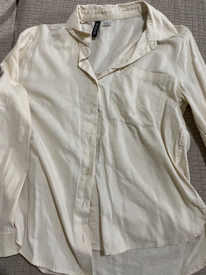 H&M Divided Cream Button-Down Shirt XXS (Category: Shirts) located in Las Pinas. Submitted by iamsayen (Listing ID 1470818198, Image 1). Description: - Brand: H&M Divided - Color: Cream - Size: XXS (EUR/UK XXS, CN 155/76A) - Style: Long sleeve button-down shirt with collar and single left chest pocket - Material: Lightweight and comfortable - Condition/Vibe: Classic everyday basic, very easy to mix and match with different outfits.
