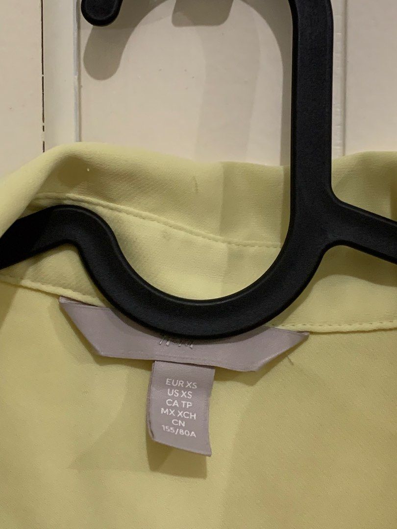 H&M Light Yellow Long Sleeve Button Down Blouse XS (Category: Longsleeves) located in Pasig City. Submitted by lovedbyri (Listing ID 1470861541, Image 3). Description: - Brand: H&M - Size: XS - Color: Light yellow - Style: Long sleeves, button cuffs, collared neckline, back box pleat - Condition: Pre-loved with a few small snags/pulls near the shoulder and back (priced accordingly) - Versatile piece for office or casual wear.