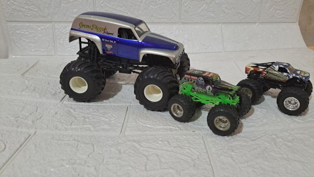 Hot Wheels Monster Jam Grave Digger & Freedom Force (Category: Vehicle & Diecast Models) located in Quezon City. Submitted by hersheejubilo (Listing ID 1470808472, Image 2). Description: - Set of 3 awesome monster truck toys - Includes large blue and silver Grave Digger the Legend van body - Includes smaller green and black Grave Digger with green chassis - Features patriotic red, white, and blue Freedom Force truck - Condition: Played-with with 