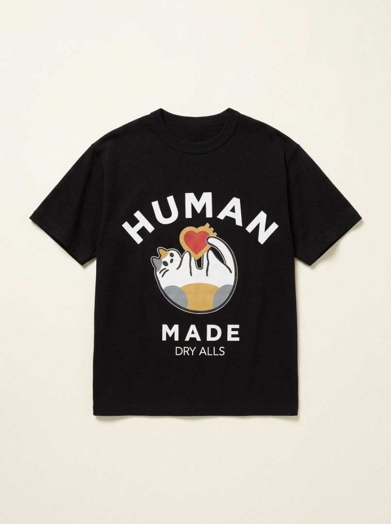 Human Made Graphic Cat T-Shirt (Category: Shirts) located in Panabo. Submitted by tlgroove (Listing ID 1470926727, Image 1). Description: Brand new condition (no issue) Color rate: 10/10 Dimes: 20.5 x 27 Key Design Elements • The Mascot Graphic: The center of the chest features a playful, stylized cartoon cat mascot hugging a prominent orange and red Human Made heart emblem. Human Made frequently uses whimsical animal graphics (like ducks, tigers