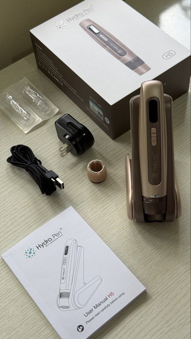 HydraPen H5 Microneedling Beauty Instrument (Category: Face Care) located in Pasig City. Submitted by acinomaral (Listing ID 1470786309, Image 2). Description: - Item: HydraPen H5 Wireless Microneedling Device - Color: Elegant Gold Finish - Condition: Excellent, complete with original box - Inclusions: Charging dock, power adapter, USB-C cable, attachment rings, and user manual - Extras: Includes 2 brand new, sealed needle cartridges - Perfect fo
