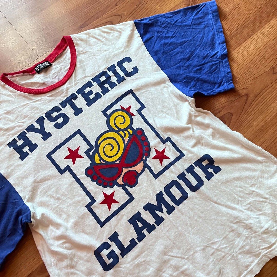 Hysteric Glamour Graphic Print Ringer Tee (Category: Tshirts & Polo Shirts ) located in Caloocan City. Submitted by landcruiser76__ (Listing ID 1470776766, Image 2). Description: Hysteric Glamour ringer t-shirt in white with bold blue sleeves and red collar trim. Large varsity letter H graphic on the front featuring the iconic blonde character and stars. Back print has the same Hysteric Glamour character artwork in red lettering. Short sleeves, r