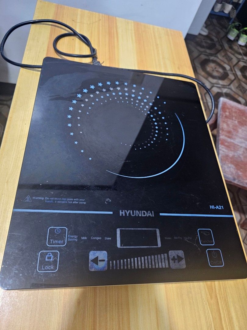 Hyundai HI-A21 Induction Cooker (Category: Cookers) located in Caloocan City. Submitted by smart_shoppers_ville (Listing ID 1470749905, Image 2). Description: - Brand/Model: Hyundai -A21 Induction Cooker - Design: Sleek black glass top with touch control panel and digital display - Cooking Modes: Preset options for water, stir fry, hot pot, milk, congee, stew, and energy saving - Condition: Bottom vent fan and model sticker intact, powers up norm