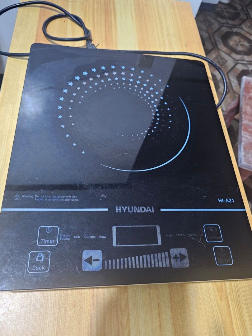 Hyundai HI-A21 Induction Cooker (Category: Cookers) located in Caloocan City. Submitted by smart_shoppers_ville (Listing ID 1470749905, Image 1). Description: - Brand/Model: Hyundai -A21 Induction Cooker - Design: Sleek black glass top with touch control panel and digital display - Cooking Modes: Preset options for water, stir fry, hot pot, milk, congee, stew, and energy saving - Condition: Bottom vent fan and model sticker intact, powers up norm
