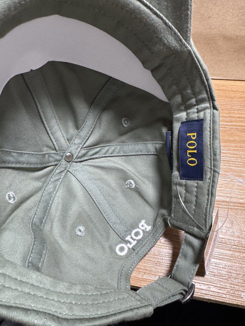 INDONESIA BRAND POLO CAP (Category: Caps & Hats) located in Manila. Submitted by leiiplayys (Listing ID 1470843412, Image 3). Description: - Brand: Polo Ralph Lauren - Color: Olive green with white embroidery - Details: White embroidered pony logo on front, white POLO lettering on back - Hardware: Adjustable strap with POLO-engraved metal buckle - Interior: Navy blue tag with yellow POLO text - Condition: Brand new, unworn, clean fabric with orig