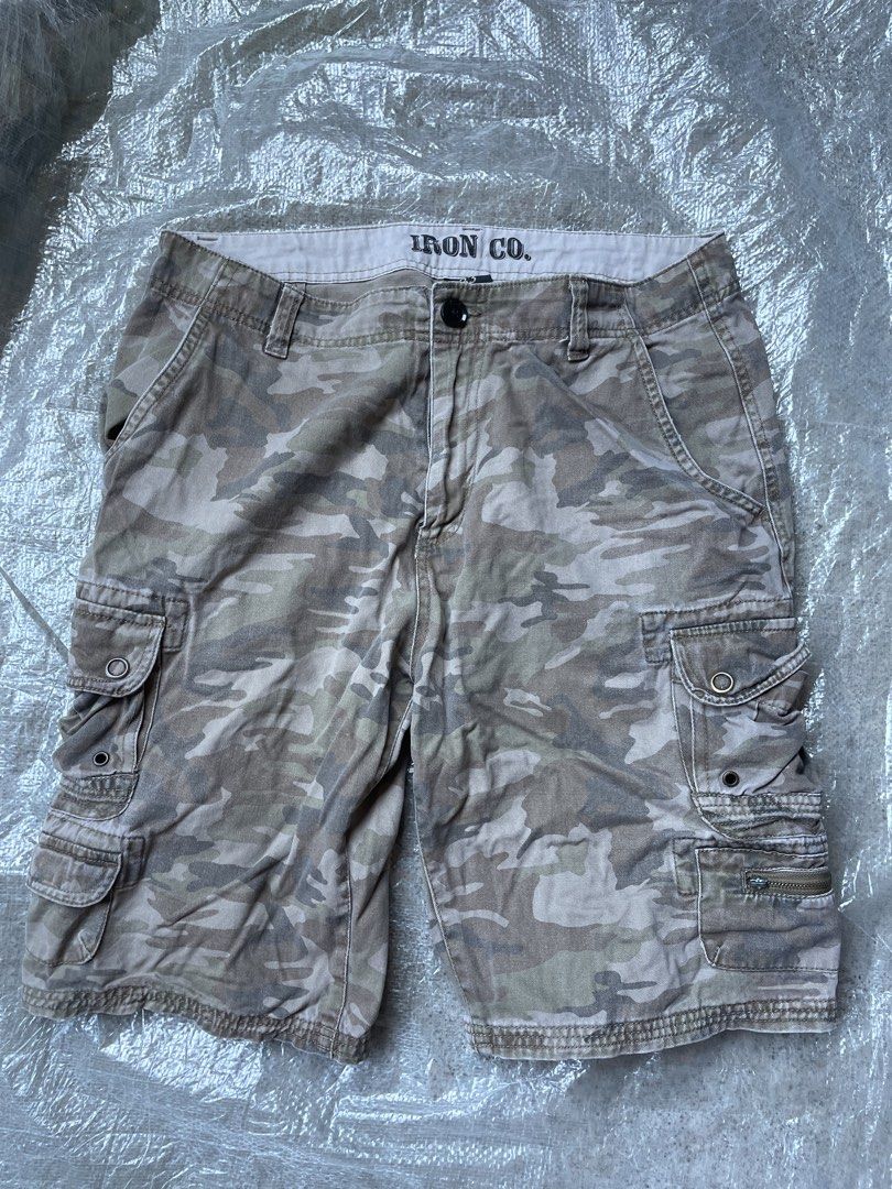 IRON CO. Camouflage Cargo Shorts Size 33 (Category: Shorts) located in Siniloan. Submitted by rethr1ft (Listing ID 1470837654, Image 1). Description: - Brand: IRON CO. - Style: Cargo shorts in camo print - Size: 33 - Material: 100% cotton - Features: Multiple side and back pockets with button and zippered compartments - Condition/Use: Great for everyday casual wear or outdoor activities.