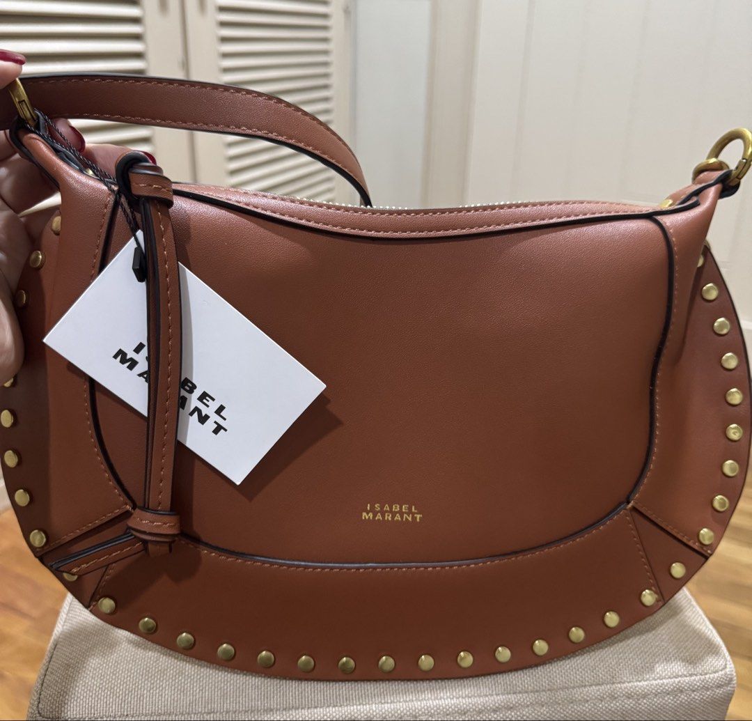ISABEL MARANT OSKAN MOON BAG – BROWN (Category: Luxury Bags & Wallets) located in Cebu City. Submitted by toteladyph (Listing ID 1470743554, Image 1). Description: **OG Quality - Rare Find** Gorgeous Isabel Marant Oskan Moon Bag in a rich cognac brown shade with gold-tone stud detailing and hardware. A signature bohemian-chic design that can be styled as a shoulder bag or crossbody. Details: • Brand: Isabel Marant • Model: Oskan Moon • Color: Bro