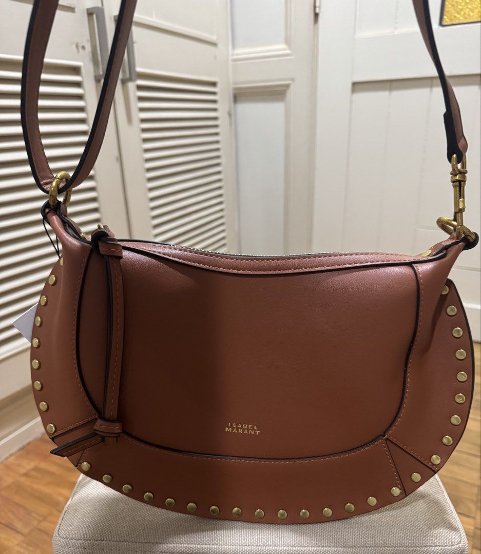 ISABEL MARANT OSKAN MOON BAG – BROWN (Category: Luxury Bags & Wallets) located in Cebu City. Submitted by toteladyph (Listing ID 1470743554, Image 3). Description: **OG Quality - Rare Find** Gorgeous Isabel Marant Oskan Moon Bag in a rich cognac brown shade with gold-tone stud detailing and hardware. A signature bohemian-chic design that can be styled as a shoulder bag or crossbody. Details: • Brand: Isabel Marant • Model: Oskan Moon • Color: Bro