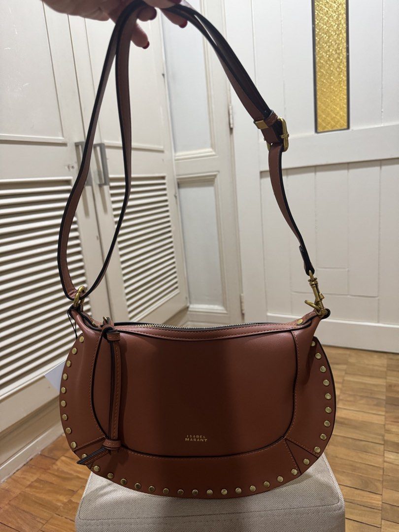 ISABEL MARANT OSKAN MOON BAG – BROWN (Category: Luxury Bags & Wallets) located in Cebu City. Submitted by toteladyph (Listing ID 1470743554, Image 2). Description: **OG Quality - Rare Find** Gorgeous Isabel Marant Oskan Moon Bag in a rich cognac brown shade with gold-tone stud detailing and hardware. A signature bohemian-chic design that can be styled as a shoulder bag or crossbody. Details: • Brand: Isabel Marant • Model: Oskan Moon • Color: Bro
