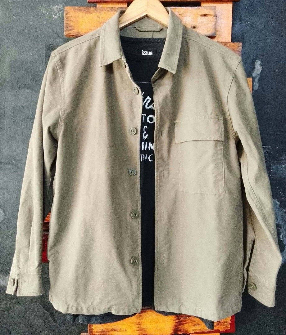 Izzue Khaki Utility Jacket (Category: Coats, Jackets and Outerwear) located in Manila. Submitted by fastdragon_62f8c6 (Listing ID 1470854901, Image 3). Description: - Brand: Izzue - Color: Khaki brown - Style: Utility jacket - Closure: Button-up front with pointed collar - Pockets: Single flap pocket on the left chest - Details: Button cuffs and clean back design with vertical seam - Condition: Great for versatile daily layering.