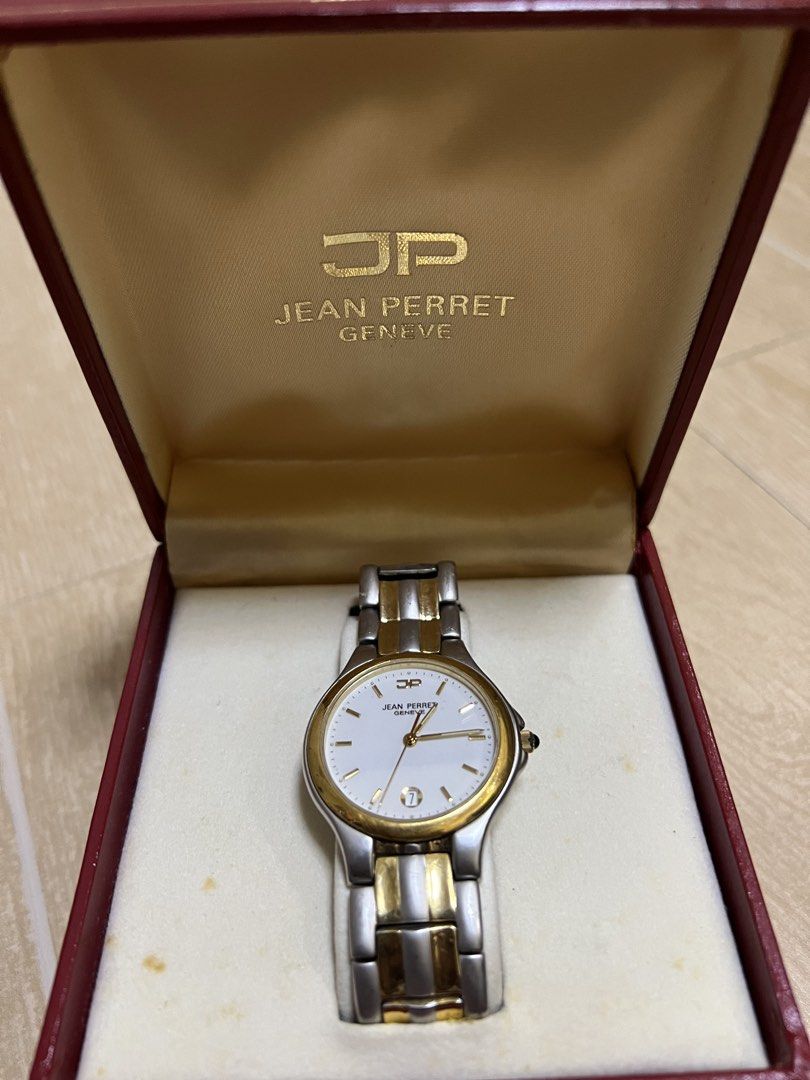 Jean Perret Geneva Two-Tone Quartz Watch with Box (Category: Women's Watches) located in San Fernando. Submitted by mharvzb (Listing ID 1470856949, Image 1). Description: - Brand: Jean Perret Geneva - Unisex - Movement: Swiss made quartz - Materials: Two-tone stainless steel and gold finish - Dial: White with gold hands and date window at 6 o'clock - Crystal: Scratch-resistant sapphire crystal - Inclusion: Original red branded presentation box - 