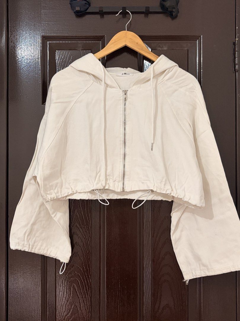 J.M White Cropped Zip-Up Hoodie (Category: Coats, Jackets and Outerwear) located in Marikina City. Submitted by _bananahanaa (Listing ID 1470802402, Image 1). Description: - Brand/Model: J.M. White Zip-Up Hoodie - Fit: Trendy cropped length with an adjustable drawstring hem - Details: Silver-tone metal hardware and zippers - Sleeves: Wide long sleeves with adjustable elastic cords at the cuffs - Style: Clean solid white color, perfect to pair wit