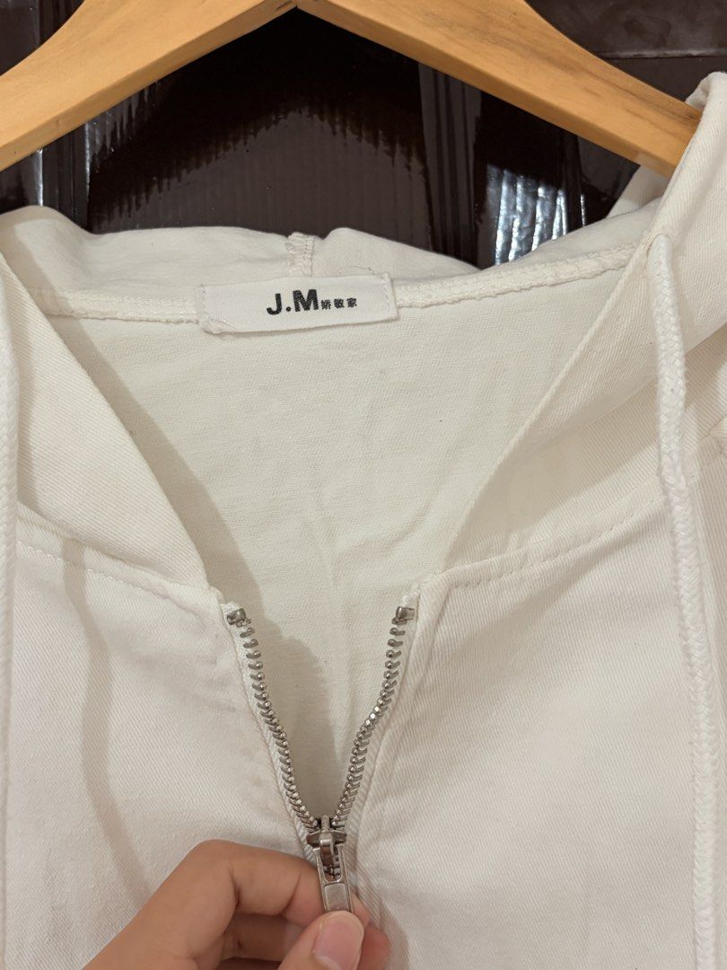J.M White Cropped Zip-Up Hoodie (Category: Coats, Jackets and Outerwear) located in Marikina City. Submitted by _bananahanaa (Listing ID 1470802402, Image 3). Description: - Brand/Model: J.M. White Zip-Up Hoodie - Fit: Trendy cropped length with an adjustable drawstring hem - Details: Silver-tone metal hardware and zippers - Sleeves: Wide long sleeves with adjustable elastic cords at the cuffs - Style: Clean solid white color, perfect to pair wit