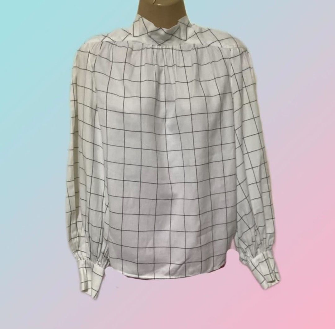 Joie White Windowpane Check Bow Neck Blouse (Category: Blouses) located in Paranaque City. Submitted by calm_youngstore7 (Listing ID 1470759919, Image 2). Description: 70% OFF RETAIL! BNWT - Brand/Style: Joie white blouse with black windowpane check pattern - Sleeves: Long bishop sleeves with button cuffs - Neckline: High neck featuring a versatile, removable tie bow detail - Fabric: Lightweight and breathable material - Versatility: Perfect for 