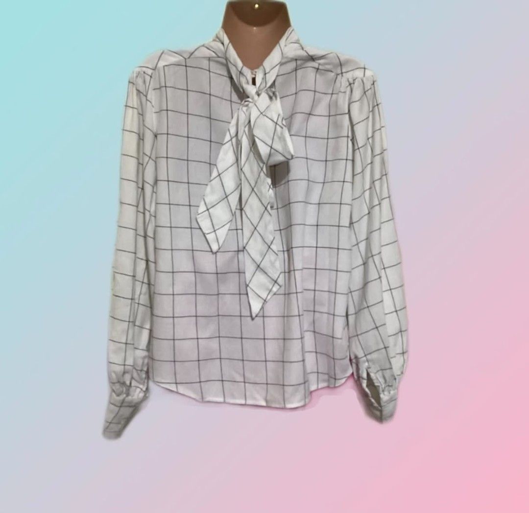 Joie White Windowpane Check Bow Neck Blouse (Category: Blouses) located in Paranaque City. Submitted by calm_youngstore7 (Listing ID 1470759919, Image 3). Description: 70% OFF RETAIL! BNWT - Brand/Style: Joie white blouse with black windowpane check pattern - Sleeves: Long bishop sleeves with button cuffs - Neckline: High neck featuring a versatile, removable tie bow detail - Fabric: Lightweight and breathable material - Versatility: Perfect for 