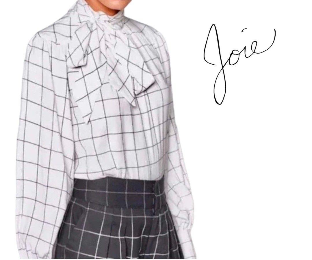 Joie White Windowpane Check Bow Neck Blouse (Category: Blouses) located in Paranaque City. Submitted by calm_youngstore7 (Listing ID 1470759919, Image 1). Description: 70% OFF RETAIL! BNWT - Brand/Style: Joie white blouse with black windowpane check pattern - Sleeves: Long bishop sleeves with button cuffs - Neckline: High neck featuring a versatile, removable tie bow detail - Fabric: Lightweight and breathable material - Versatility: Perfect for 