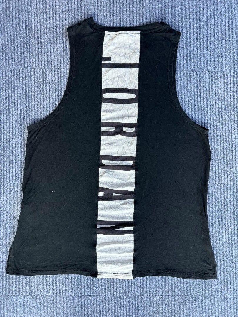 Jordan Air (Category: Activewear) located in Imus. Submitted by alecsssss (Listing ID 1470767745, Image 2). Description: - Brand: Jordan - Color: Black with white accents - Size: Large (L) - Material: Dri-FIT moisture-wicking fabric - Design: White Jumpman logo on front, vertical Jordan lettering on back mesh panel - Fit: Crew neck, sleeveless - Condition: Excellent for workouts and casual wear.