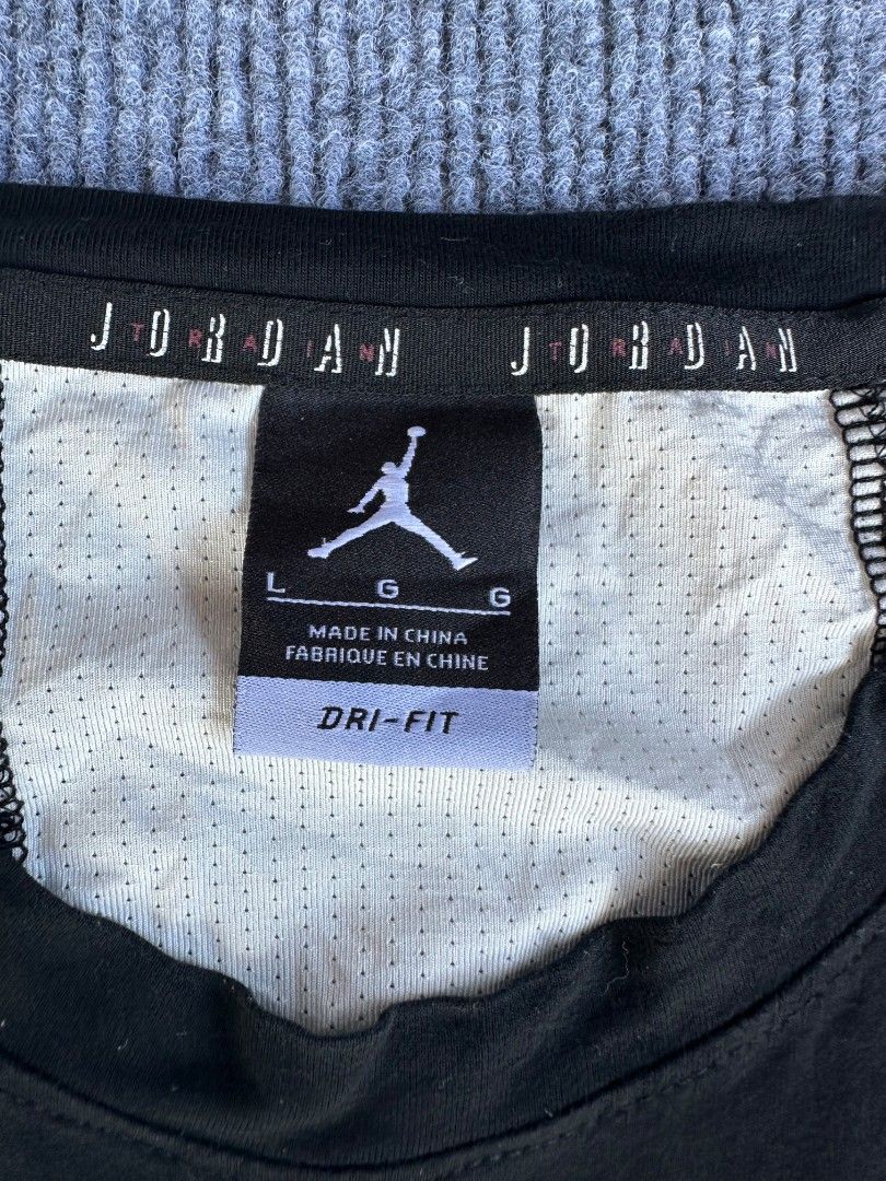 Jordan Air (Category: Activewear) located in Imus. Submitted by alecsssss (Listing ID 1470767745, Image 3). Description: - Brand: Jordan - Color: Black with white accents - Size: Large (L) - Material: Dri-FIT moisture-wicking fabric - Design: White Jumpman logo on front, vertical Jordan lettering on back mesh panel - Fit: Crew neck, sleeveless - Condition: Excellent for workouts and casual wear.