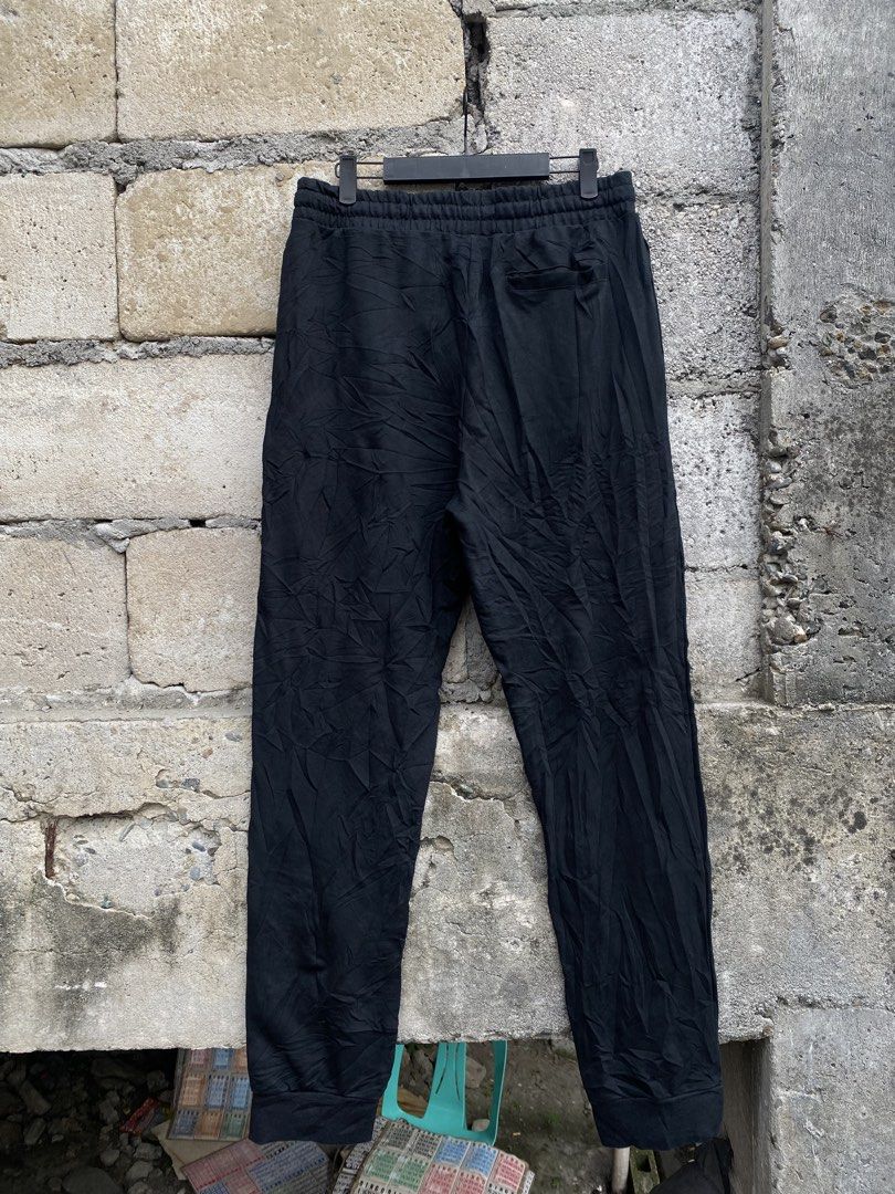 Jordan Black Jogger Pants (Category: Joggers) located in Candaba. Submitted by dejesus.bench17 (Listing ID 1470931648, Image 2). Description: - Brand: Jordan - Color: Black with colorful letter graphics - Size: XXL - Features: Jumpman logo on right thigh, adjustable drawstring waistband with branded aglets, and right-side back pocket - Origin: Made in China - Style: Streetwear essential, perfect for pairing with your favorite sneakers - Dimes: W3