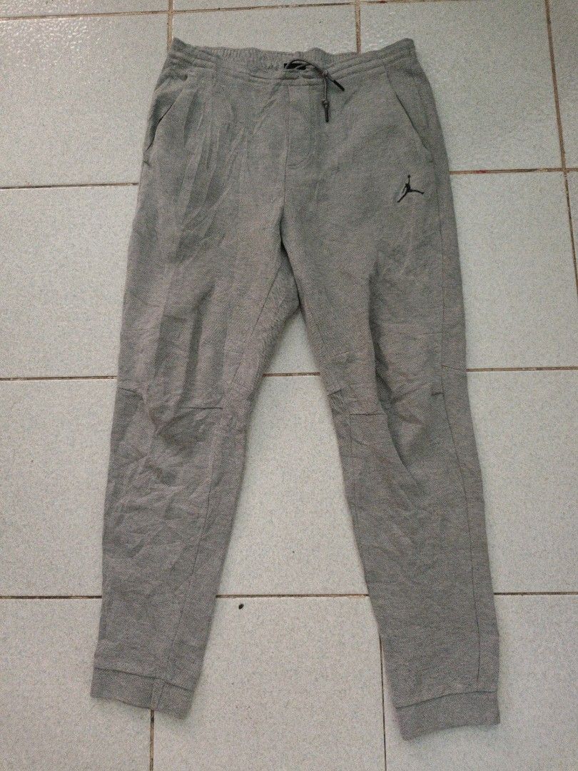 Jordan Grey Sweatpants Joggers Size 34 (Category: Joggers) located in Isulan. Submitted by jaysthrift (Listing ID 1470794976, Image 1). Description: - Brand: Jordan - Color: Grey - Size: Large (34) - Waistband: Elastic with adjustable drawstring - Cuffs: Ribbed at ankles - Pockets: Two front pockets + secure zipper pockets in the back - Logo: Embroidered Jumpman logo on left thigh - Authenticity: Fabric tags attached inside with serial number 724