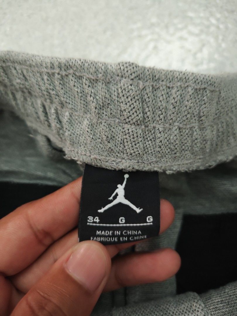 Jordan Grey Sweatpants Joggers Size 34 (Category: Joggers) located in Isulan. Submitted by jaysthrift (Listing ID 1470794976, Image 3). Description: - Brand: Jordan - Color: Grey - Size: Large (34) - Waistband: Elastic with adjustable drawstring - Cuffs: Ribbed at ankles - Pockets: Two front pockets + secure zipper pockets in the back - Logo: Embroidered Jumpman logo on left thigh - Authenticity: Fabric tags attached inside with serial number 724