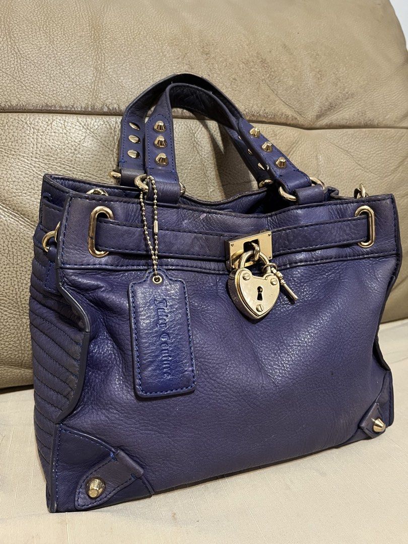 Juicy Couture Leather Satchel (Category: Luxury Bags & Wallets) located in Calamba. Submitted by jupreloved_ (Listing ID 1470793397, Image 2). Description: Juicy Couture deep purple leather satchel bag with gold-tone hardware, heart-shaped lock, studded handles, and leopard print interior lining. Includes dual top handles and an adjustable shoulder strap. Brand: Juicy Couture Size: Small Shipping through J&T. Payment are strictly through GCASH on