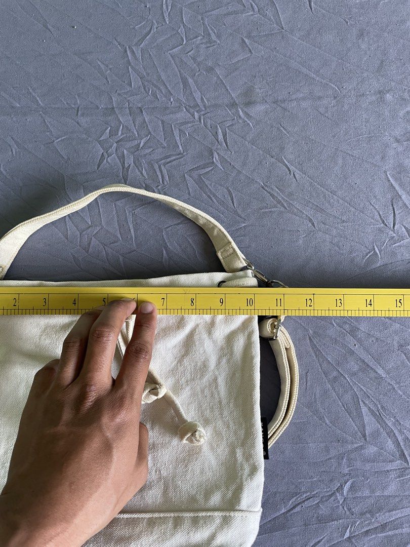 Kangol Canvas Bucket Bag Off White (Category: Shoulder Bags) located in Cagayan de Oro. Submitted by jekdels05 (Listing ID 1470745116, Image 2). Description: - Brand: Kangol - Color: Off-white canvas with black embroidered kangaroo logo - Closure: Drawstring top - Interior: Includes a handy inside pocket with the official brand patch - Straps: Comes with a top handle plus an adjustable and detachable shoulder strap with chic silver-tone hardware 