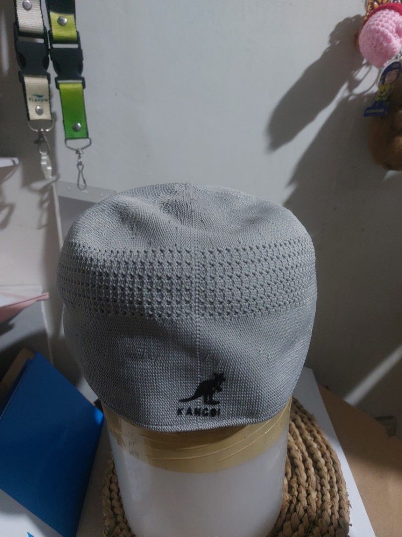 Kangol Grey Knit Beret Flat Cap (Category: Hats & Beanies) located in Magarao. Submitted by hotdogsandwich.flower (Listing ID 1470750020, Image 1). Description: - Brand: Kangol - Color: Grey - Style: Classic flat cap / knit beret - Features: Breathable mesh pattern sections and textured fabric - Branding: Iconic black embroidered kangaroo logo on the side - Interior: Official Kangol branding tag with Union Jack flag detail - Condition: Excellent,