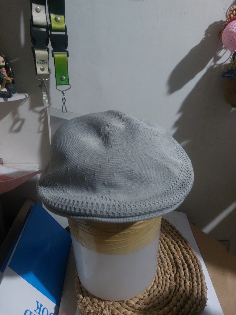 Kangol Grey Knit Beret Flat Cap (Category: Hats & Beanies) located in Magarao. Submitted by hotdogsandwich.flower (Listing ID 1470750020, Image 2). Description: - Brand: Kangol - Color: Grey - Style: Classic flat cap / knit beret - Features: Breathable mesh pattern sections and textured fabric - Branding: Iconic black embroidered kangaroo logo on the side - Interior: Official Kangol branding tag with Union Jack flag detail - Condition: Excellent,