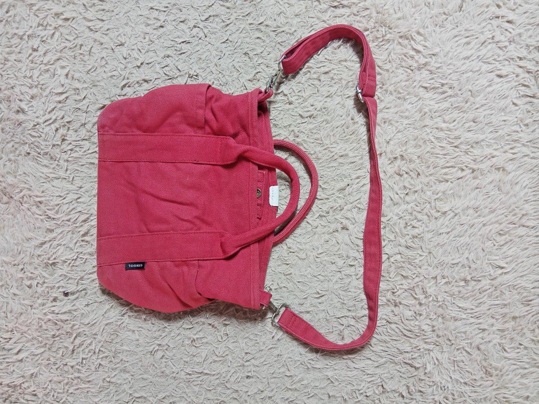 Kangol Red Canvas Tote Crossbody Bag (Category: Tote Bags) located in Lucban. Submitted by aeronroyyy (Listing ID 1470809699, Image 2). Description: - Brand: Kangol - Color: Bright red with white kangaroo logo - Material: 100% cotton canvas (Made in China) - Carry Options: Dual top handles and adjustable shoulder strap - Exterior: Front pocket and two side slip pockets - Closure: Snap button main compartment - Interior: Red logo-lined fabric with