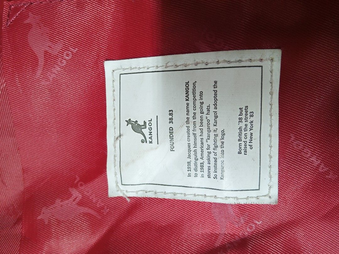 Kangol Red Canvas Tote Crossbody Bag (Category: Tote Bags) located in Lucban. Submitted by aeronroyyy (Listing ID 1470809699, Image 3). Description: - Brand: Kangol - Color: Bright red with white kangaroo logo - Material: 100% cotton canvas (Made in China) - Carry Options: Dual top handles and adjustable shoulder strap - Exterior: Front pocket and two side slip pockets - Closure: Snap button main compartment - Interior: Red logo-lined fabric with