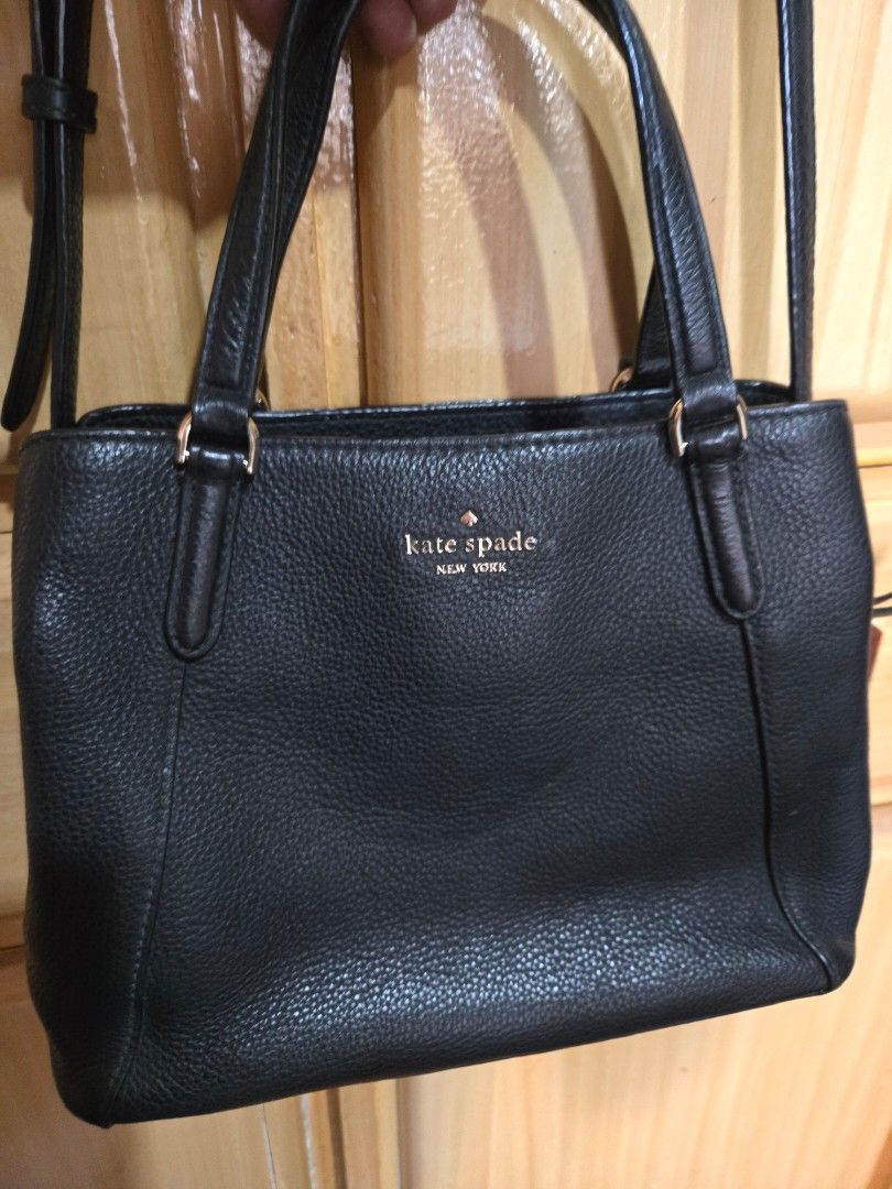 Kate Spade Black Leather Tote Shoulder Bag (Category: Tote Bags) located in Quezon City. Submitted by mycloset_2016 (Listing ID 1470767916, Image 1). Description: - Brand: Kate Spade - Material: Premium black pebbled leather - Hardware: Elegant gold-tone accents with secure zipper closure - Versatile Carry: Includes top carry handles and an adjustable long shoulder strap - Practical Design: Features side gussets and protective metal feet on the b