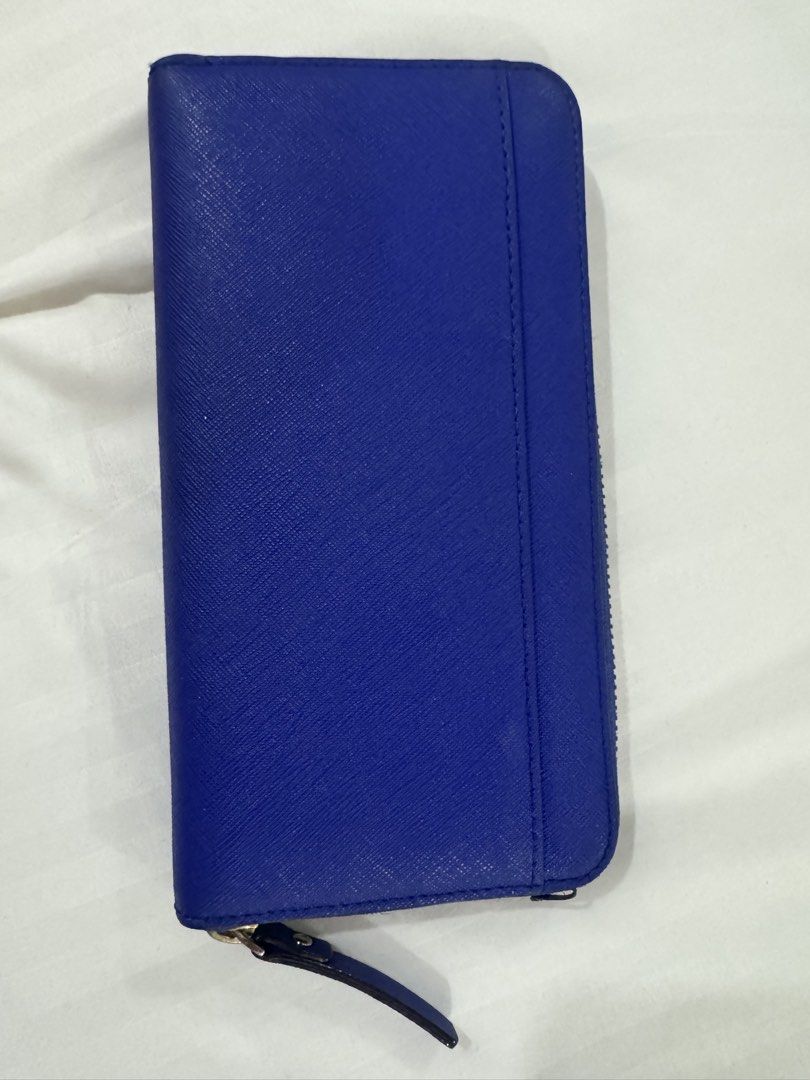 Kate Spade New York Blue Zip Around Wallet (Category: Wallets & Card holders) located in Manila. Submitted by prelovemd (Listing ID 1470826564, Image 2). Description: - Authentic Kate Spade wallet in blue Saffiano leather - Secure zip-around closure with elegant gold-tone hardware - Stylish cream and black polka dot fabric interior lining - Organized with multiple card slots, cash compartments, and a zippered coin pocket - Flaws as shown on pictu