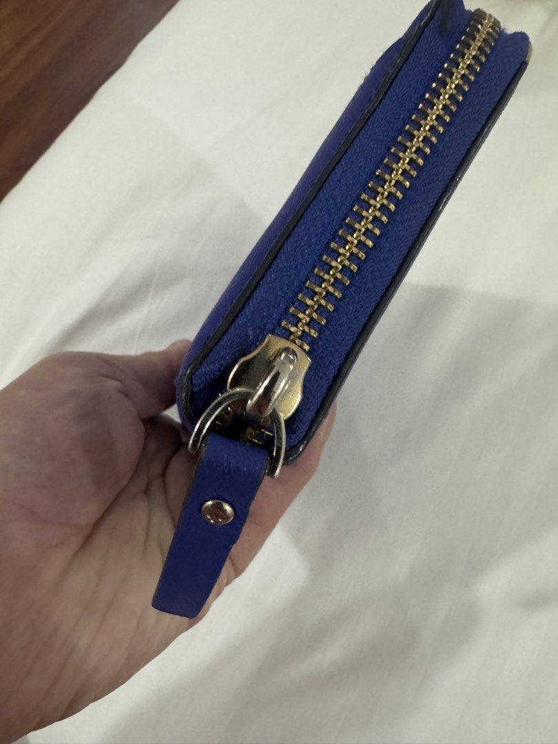 Kate Spade New York Blue Zip Around Wallet (Category: Wallets & Card holders) located in Manila. Submitted by prelovemd (Listing ID 1470826564, Image 3). Description: - Authentic Kate Spade wallet in blue Saffiano leather - Secure zip-around closure with elegant gold-tone hardware - Stylish cream and black polka dot fabric interior lining - Organized with multiple card slots, cash compartments, and a zippered coin pocket - Flaws as shown on pictu