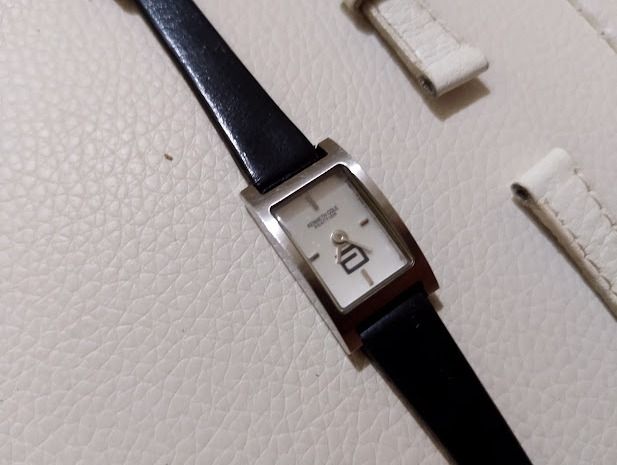 Kenneth Cole rectangular wristwatch with extra white strap (Category: Women's Watches) located in Quezon City. Submitted by susmaryosep1 (Listing ID 1470789323, Image 1). Description: - Brand: Kenneth Cole women's watch - Design: Minimalist rectangular silver-tone case with a clean white dial and simple hour markers - Straps: Comes with a slim black leather strap PLUS an extra interchangeable white leather strap - Versatility: Great everyday acce