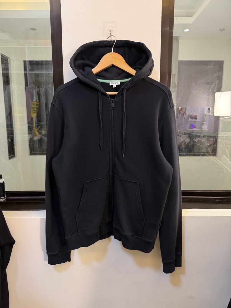 Kenzo Paris Full-Zip Hooded Sweatshirt (Category: Coats, Jackets and Outerwear) located in Paranaque City. Submitted by preluxeshop_ph (Listing ID 1470810834, Image 2). Description: Brand: Kenzo Paris -Style: Full-Zip Hooded Sweatshirt / Zip Hoodie -Color: Dark Navy / Black with contrast light green inner neck taping -Design Features: Large iconic Kenzo Tiger Head embroidery across the back, attached drawstring hood, full front zipper with “K” br