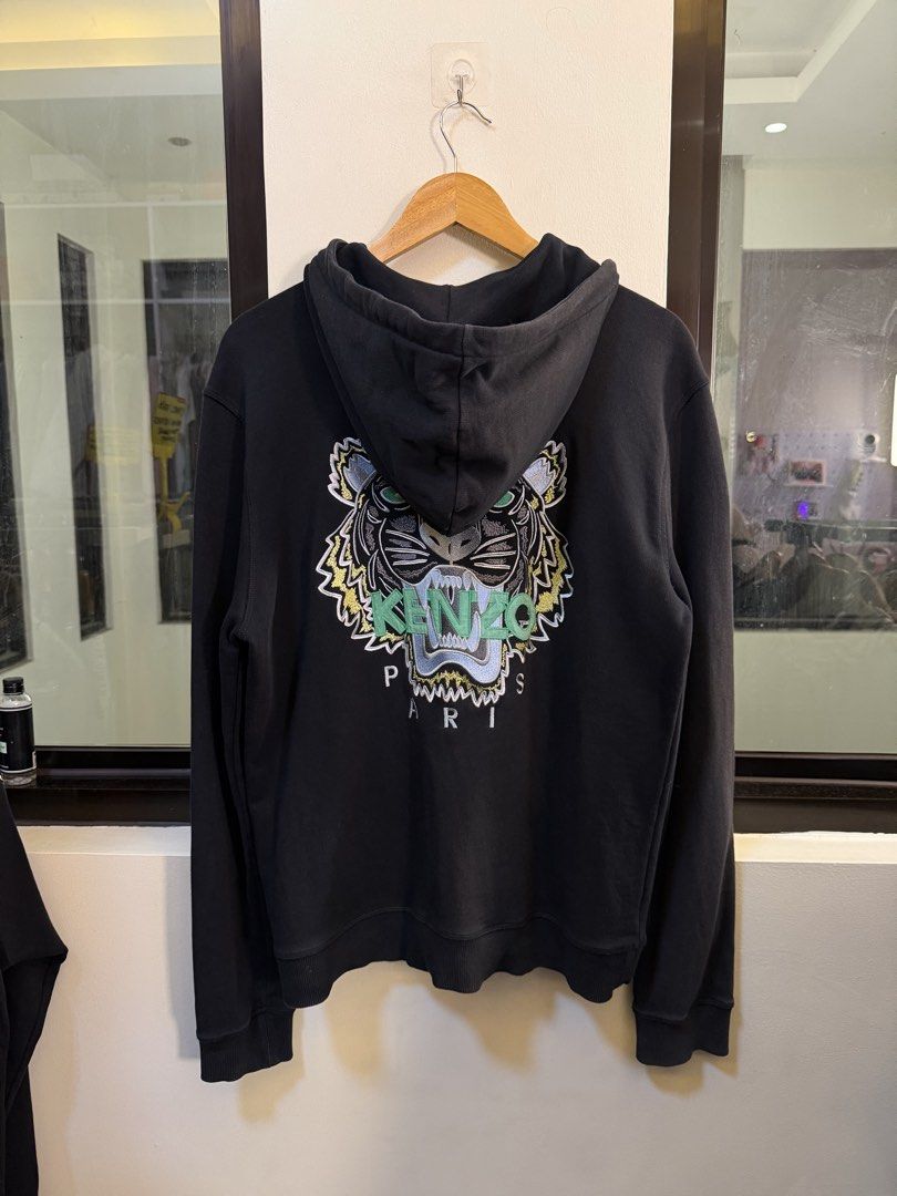 Kenzo Paris Full-Zip Hooded Sweatshirt (Category: Coats, Jackets and Outerwear) located in Paranaque City. Submitted by preluxeshop_ph (Listing ID 1470810834, Image 3). Description: Brand: Kenzo Paris -Style: Full-Zip Hooded Sweatshirt / Zip Hoodie -Color: Dark Navy / Black with contrast light green inner neck taping -Design Features: Large iconic Kenzo Tiger Head embroidery across the back, attached drawstring hood, full front zipper with “K” br