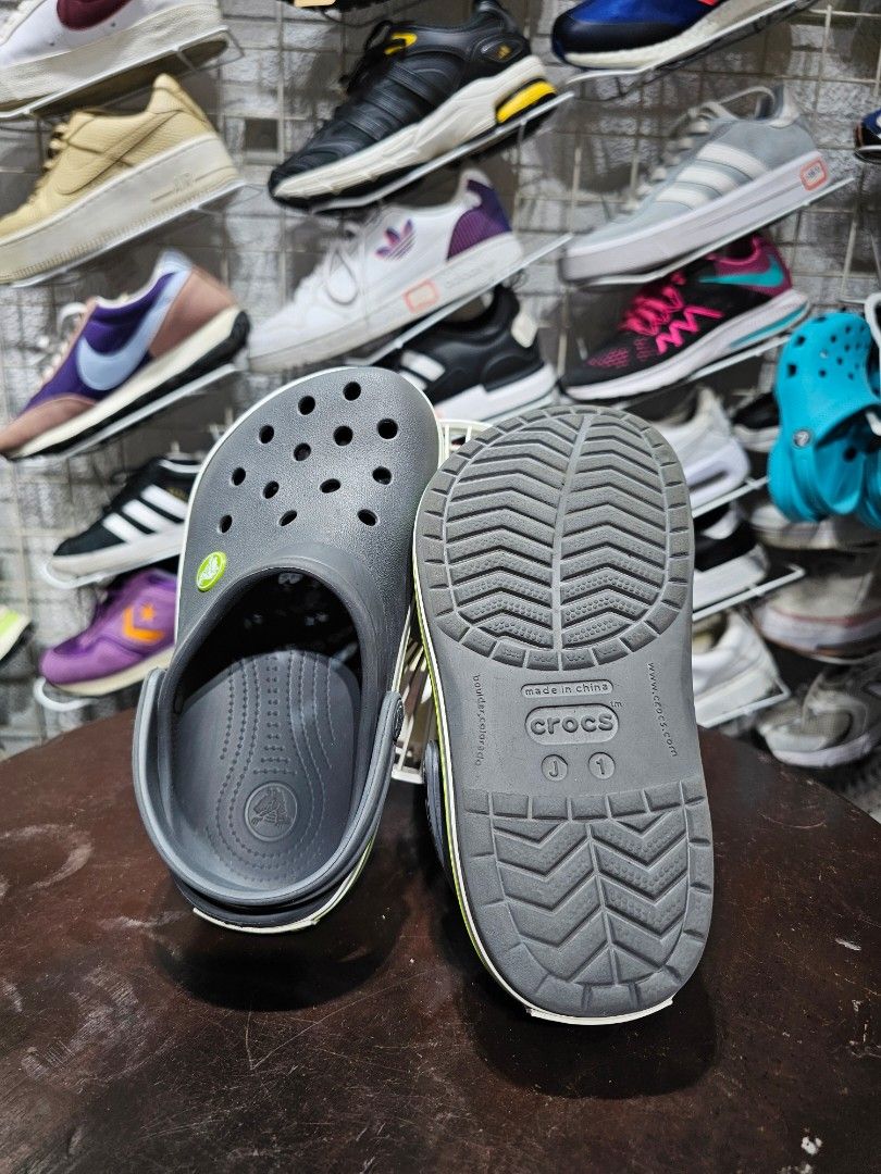 Kids Grey Crocs Crocband Clogs (FREE SHIPPING) (Category: Babies & Kids Fashion) located in Baguio. Submitted by kayeonlineshop (Listing ID 1470787907, Image 2). Description: (FREE SHIPPING!!!) Description: Selling an authentic, pre-owned pair of kids Crocs Crocband Clogs in Charcoal Grey. Features a sporty white and lime green stripe design along the sides. Super comfortable, lightweight, and perfect for active kids. Easy to wash down after play