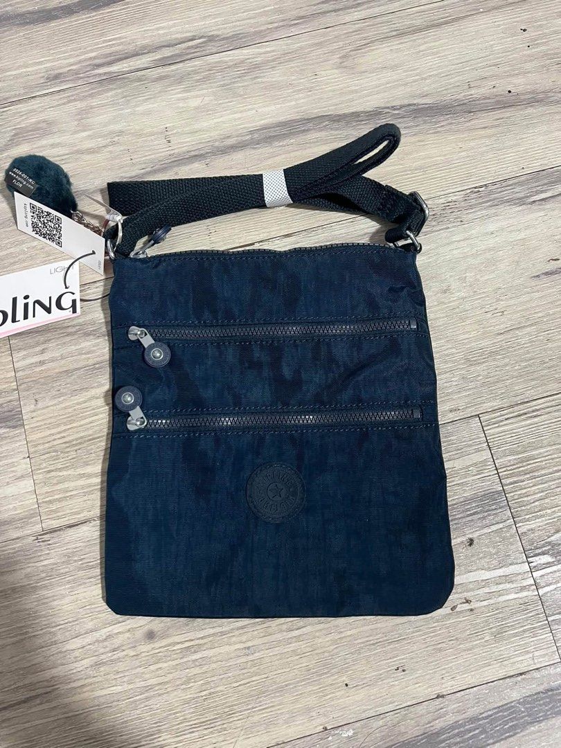 Kipling Crossbody Bag Dark Blue with Monkey Keychain (Category: Cross-body Bags) located in Baguio. Submitted by heath2600 (Listing ID 1470754144, Image 1). Description: - Authentic dark blue Kipling crossbody bag - Brand new with original product tags attached - Comes with the iconic furry monkey keychain charm - Crafted from durable, lightweight crinkle nylon fabric - Features two convenient zipped front pockets - Secure top main compartment fo