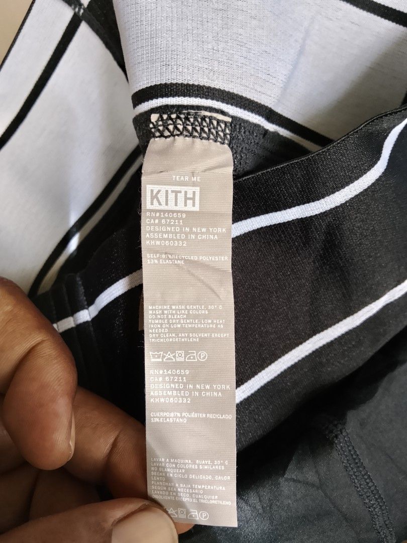 Kith Black Biker Shorts (Category: Shorts) located in Manila. Submitted by arjaygoodfind (Listing ID 1470800928, Image 3). Description: - Brand: Kith - Size: XS - Color: Black with white stripe elastic waistband and bold branding - Material: 87% recycled polyester, 13% elastane (soft, stretch fabric) - Design: Structured panel seams on front and back - Condition: Clean, interior branding and care tags intact - Care: Machine washable, ready to wea