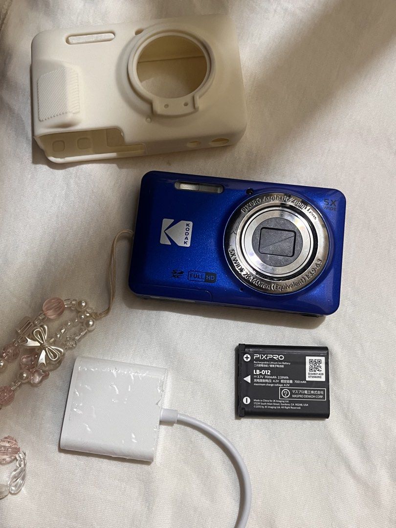 Kodak PixPro digital camera blue bundle with battery and case (Category: Cameras) located in Legazpi City. Submitted by sandras. (Listing ID 1470874945, Image 1). Description: - Model: Blue Kodak PixPro compact digital camera - Condition: Fully functional and ready to shoot - Inclusions: Rechargeable PIXPRO LB-012 battery, white silicone protective case, charging cable block, and beaded wrist strap - Storage: Uses standard SD cards - Best for: Ev
