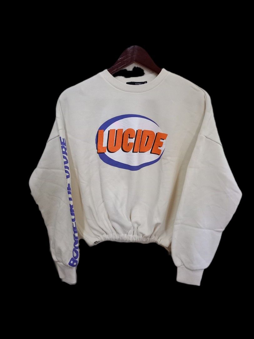 Korean Sweatshirt (Category: Longsleeves) located in General Santos City (Dadiangas). Submitted by silvkimber62755 (Listing ID 1470745935, Image 1). Description: - Style: Oversized cropped sweatshirt with drop shoulders - Color: Off-white with vibrant orange and purple 'Lucide' front graphic - Detail: Purple 'BONHEUR DE VIVRE' text running down the right sleeve - Fit: Elasticated cinched waistband for a gathered look - Finish: Comfortable ribbed 