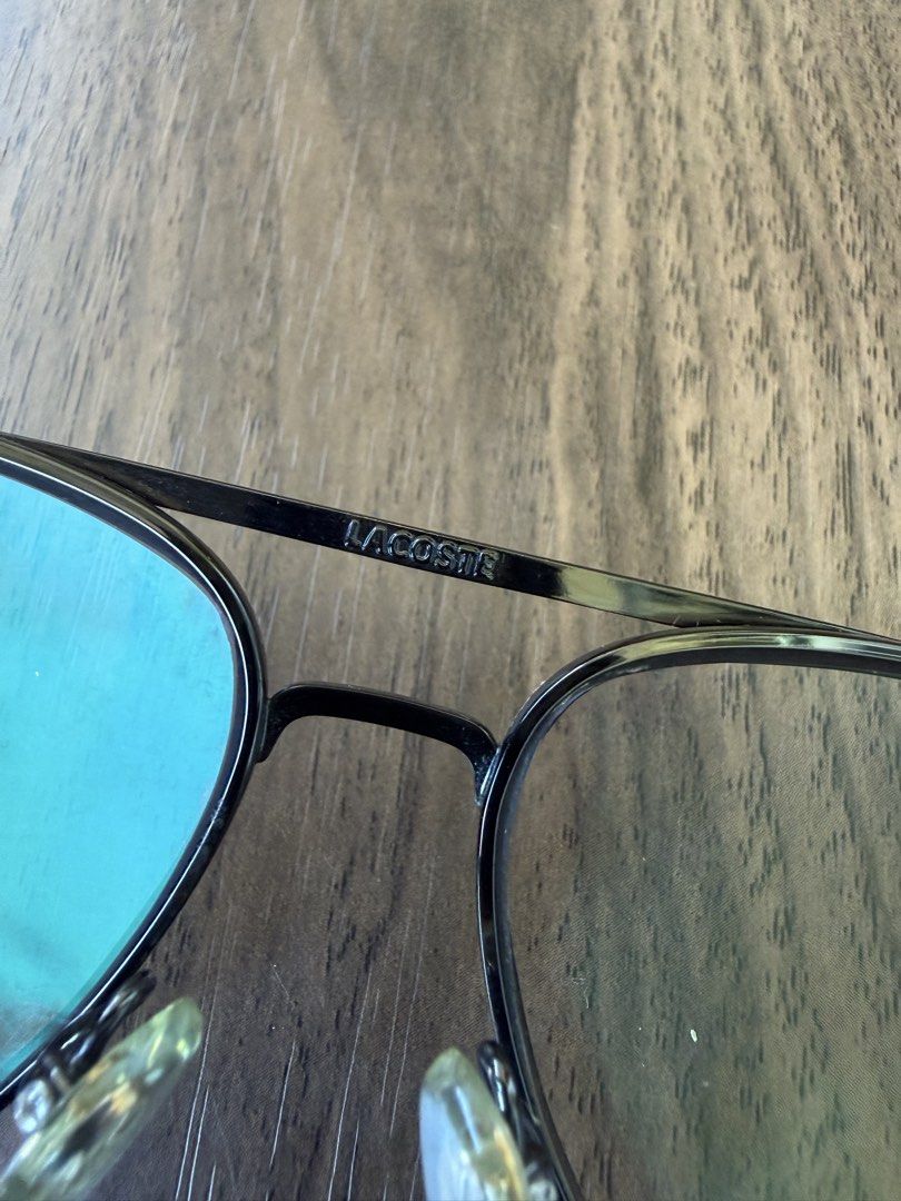 Lacoste Aviator Optical Frame Japan (Category: Sunglasses & Eyewear) located in Digos. Submitted by old_soul. (Listing ID 1470793182, Image 3). Description: Collectible!!! - Brand: Vintage Lacoste (Made in Japan) - Style: Classic aviator optical frames with double bridge - Lenses: Clear lenses installed, ready for your prescription - Details: Iconic crocodile logo embossed on adjustable nose pads - Condition: Clean overall shape with minimal sign