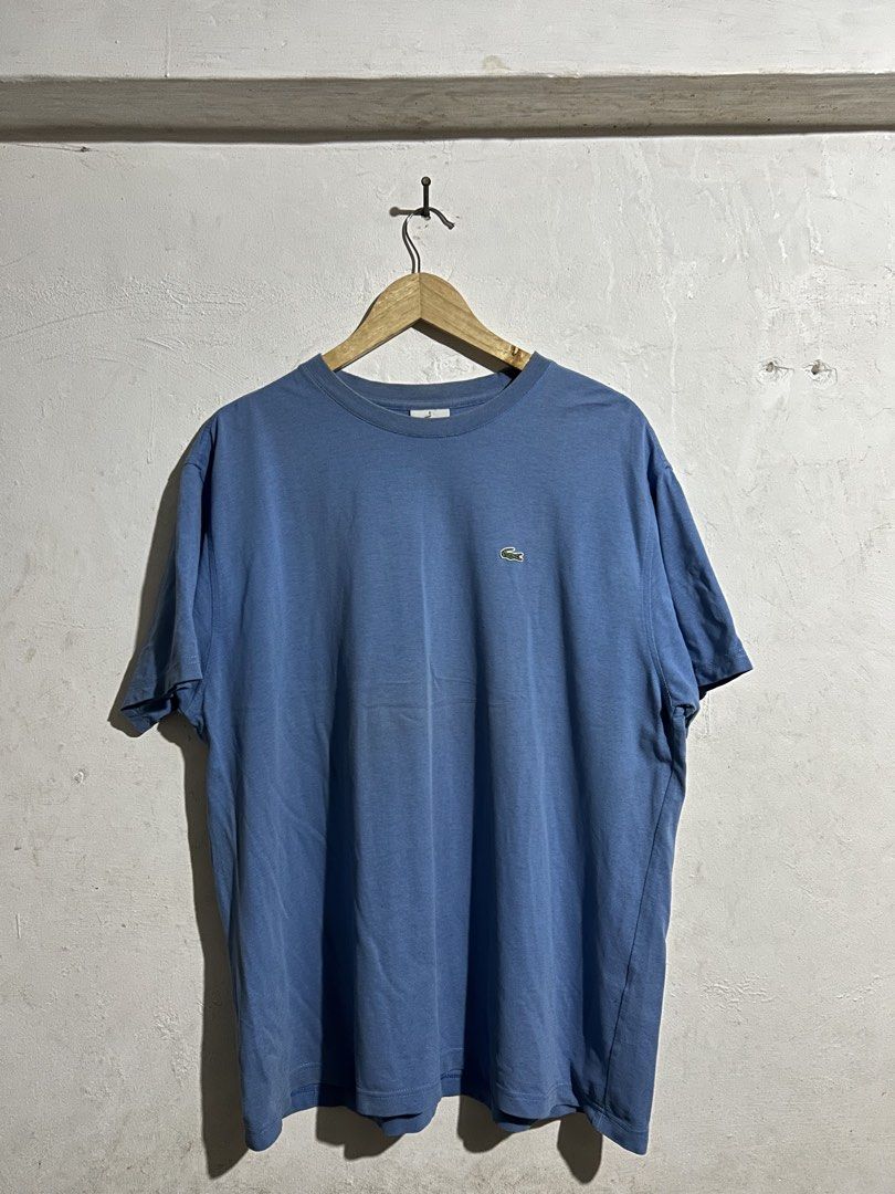 Lacoste Blue T-Shirt Size 6 Devanlay (Category: Shirts) located in Manila. Submitted by romnick907 (Listing ID 1470819183, Image 1). Description: - Brand: Lacoste (Manufactured by Devanlay) - Color: Light Blue - Size: 6 (Tag inside collar) - Material/Style: Textured fabric, classic crew neck, short sleeves - Details: Small embroidered crocodile logo on the chest - Condition: Clean overall, with minimal wear on the collar ribbing.