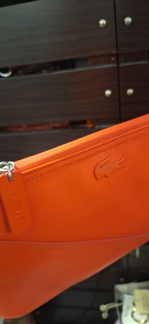 LACOSTE Body Bag (Category: Cross-body Bags) located in General Trias. Submitted by aeunice (Listing ID 1470809391, Image 2). Description: Brand: Lacoste In Good Condition. Authentic Lacoste crossbody bag in a vibrant orange color, perfect for adding a pop of color to your everyday style. Compact, stylish and easy to carry, it’s a great choice for casual outings and daily use. Meet up / Shipping via Lalamove, JnT, Gogo Express & LBC .